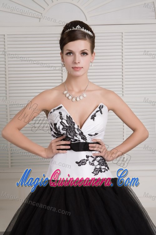 V-neck Black and White Quinceanera Dress with Embroidery and a Black Sash