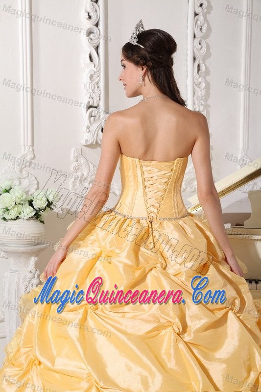 Strapless Gold Quinceanera Dress with Ruffles and a Chapel Train