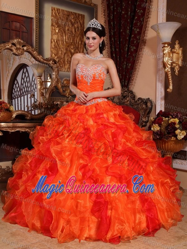 Orange Organza Quinceanera Dress with Appliques and Ruffled Skirt