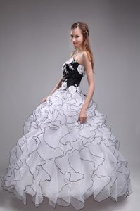 White and Black Quinceanera Dress with Ruffles and Hand Made Flowers