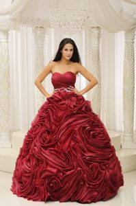 Beaded Wine Red Sweetheart Quinceanera Gown with Rolling Flowers