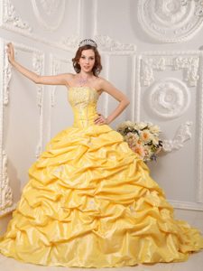 Gold Court Train Dresses for a Quince with Pick ups and Beading